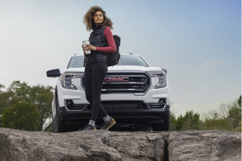 Young couple leaning against their lease vehicle